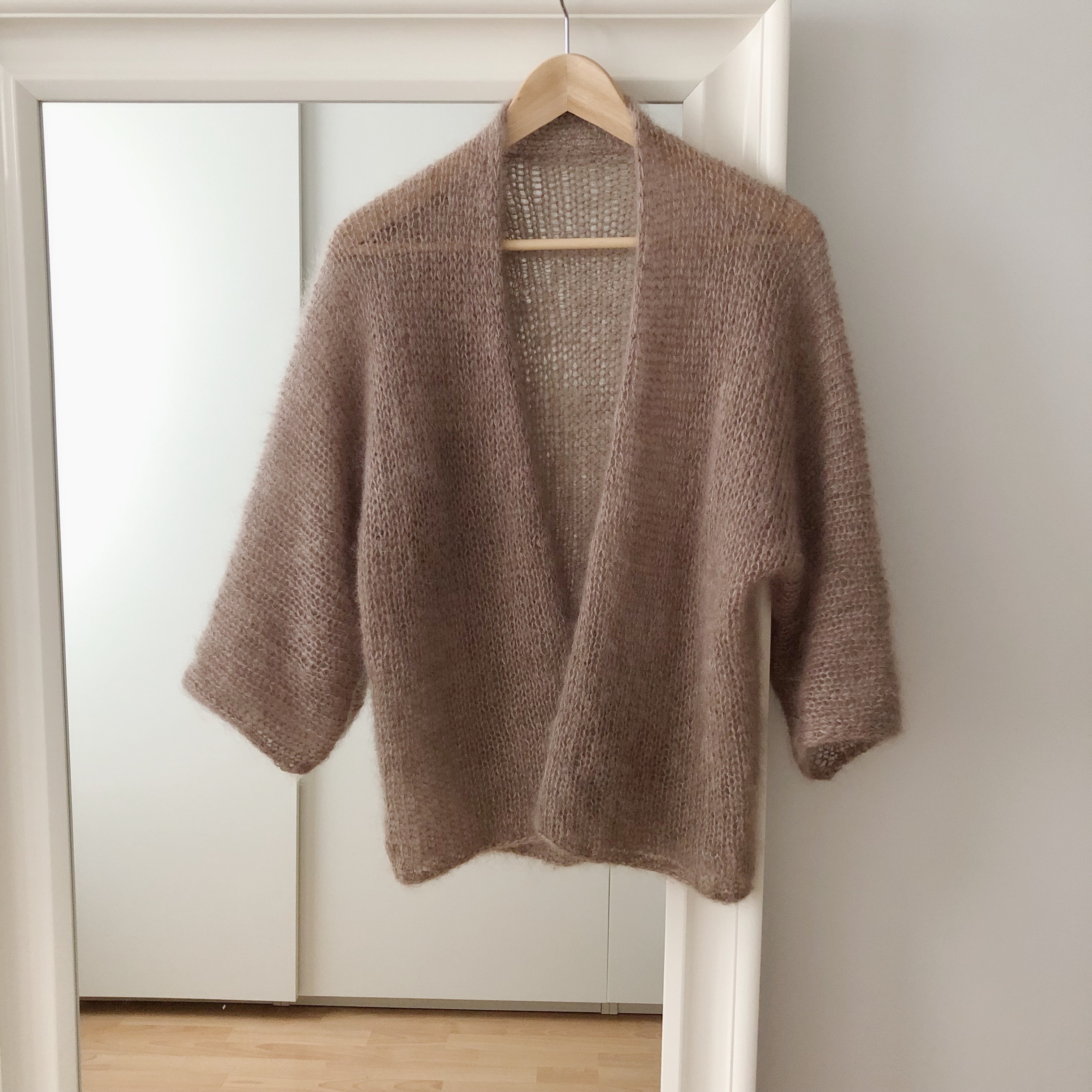 Knitting pattern for an oversize cardigan with wide batwing sleeves.